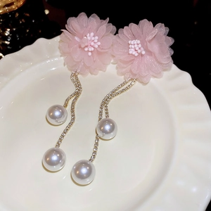 Elegant pink lace flower earrings with tassel chains and pearls on a white tray