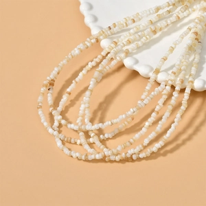 4mm irregular freshwater shell beads for handmade DIY necklaces on a ceramic plate