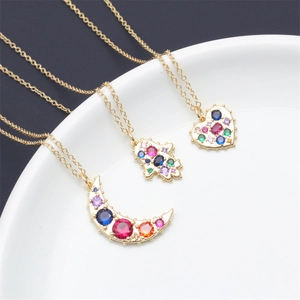 Three-piece gold-tone necklace set with colorful zircon crescent moon, hand, and heart charms