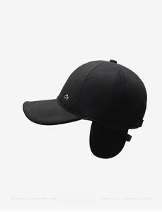 Macro view of a black wool baseball cap featuring foldable earflaps and metal logo