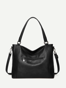 Detail of black pebbled faux leather handbag with rear zipper pocket and gunmetal hardware