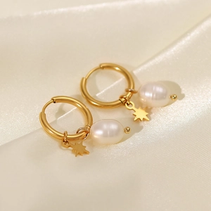 Detail of 18k gold plated hoop earrings with natural freshwater pearls and star pendants