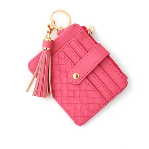 Top view of pink checkered card holder with tassel keychain and gold hardware detail