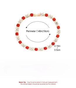 Detail view of gold alloy bracelet featuring red and white cubic zirconia with size specs