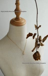 Detailed view of an 18K gold plated octagon star pendant necklace on a jewelry bust