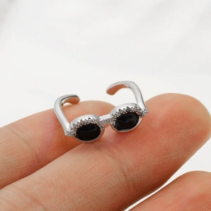 Detail of silver sunglasses ring with black enamel and white zircon micro-inlay