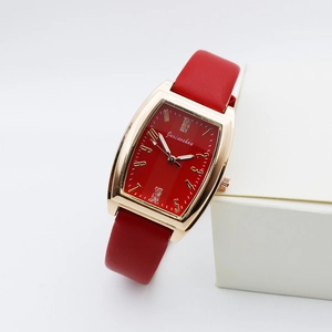 Detail view of red strap quartz watch with rose gold case and diamond accents