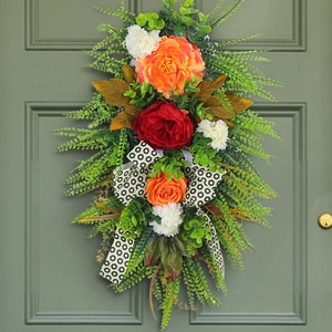 Autumn harvest door wreath with orange flowers, green leaves and leopard print ribbon