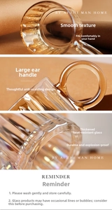 Detail of amber heat-resistant glass mug with vertical stripes and wide handle
