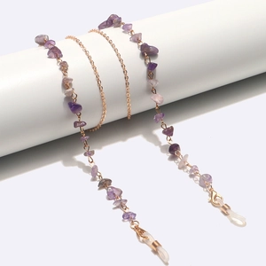 Detail of purple amethyst stone eyeglass chain with gold metal links and silicone loops