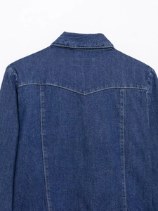 Détail du dos d'une veste en jean bleue avec coutures jaunes et tissu sergé robuste