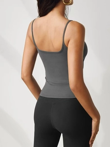 Back view of a dark gray slim-fit knitted camisole with thin straps and black leggings