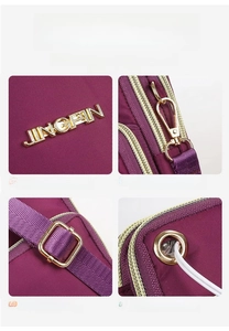 Detail view of nylon crossbody bag featuring metal logo, hooks, strap, and earphone port