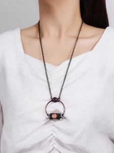 Vintage bronze necklace with white crystal druzy, amethyst, and moon phase pendant on model