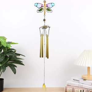 Detail of metal dragonfly wind chime with colorful glass wings and gold hanging tubes