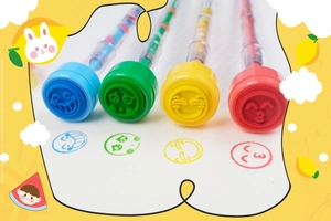 Close-up of four colorful stamp pens for children with various smiley face patterns