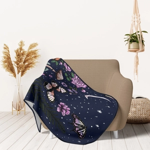 Detailed close-up of soft flannel throw blanket with floral and butterfly patterns