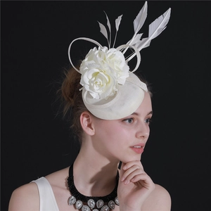 Side view of a white fascinator hat with feathers and flowers on a female model