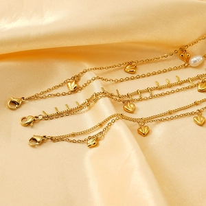 18K gold plated stainless steel bracelet with heart charms and white pearl accents