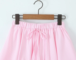 Close-up of pink and white striped elastic waistband with decorative drawstring bow