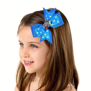 Sweet blue polka dot hair bow clip with ABC print worn by a young girl for school