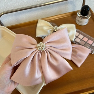 French oversized satin bow hair clip with camellia flower pearl detail in pink and white