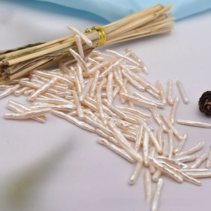Macro shot of long natural baroque toothpick pearls with iridescent white luster and texture