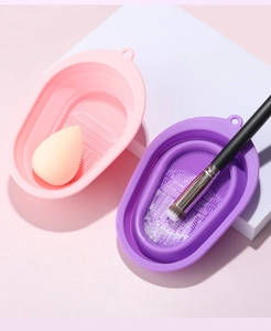 Dual texture silicone cleaning bowls in pink and purple for makeup brushes and sponges