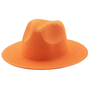 Close-up of bright orange straw fedora showing fine woven texture and structured brim