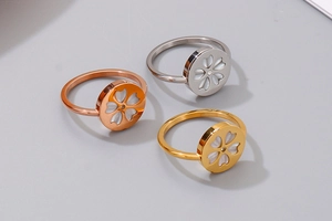 Detailed view of cherry blossom rings with white shell inlay in gold, silver, and rose gold