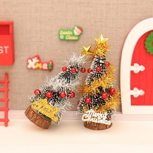 Miniature Christmas cedar trees with Merry Christmas signs and natural wooden bases