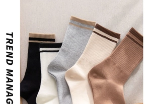 Close-up of five pairs of cotton crew socks with ribbed cuffs and contrast stripes