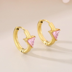 Macro shot of gold hoop earrings with pink triangle zircon and 18K vacuum plating