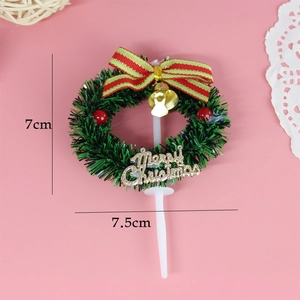 Christmas wreath cake topper with green leaves, red bow, gold bell and Merry Christmas sign