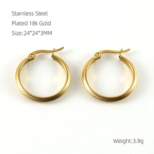 Detail of 18k gold plated stainless steel hoop earrings with diagonal texture and buckle