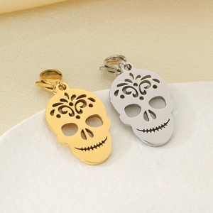 Close-up of gold and silver hollow skull pendants in stainless steel for DIY jewelry