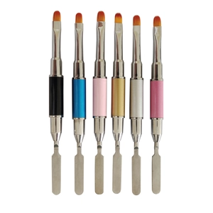 Detail of dual-ended nail tools featuring colorful handles and metal spatula tips
