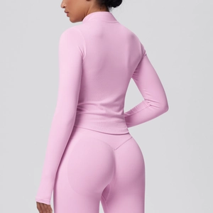 Detail view of pink slim fit yoga set featuring high-waisted leggings and long sleeve top