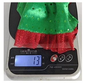 Detail of green sequin elf bottle cover weighing 13g on scale for Christmas decor