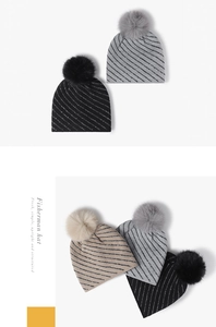 Detailed knit pattern with sequins and large faux fur pompom on striped winter beanies