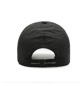 Detail view of the breathable laser-cut mesh and plastic strap on a black quick-dry cap