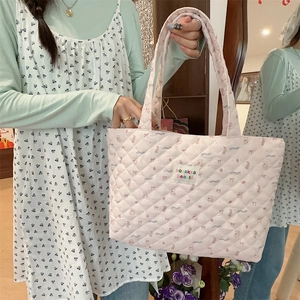 Detailed shot of pink quilted cotton tote bag featuring sweet bear and ribbon patterns