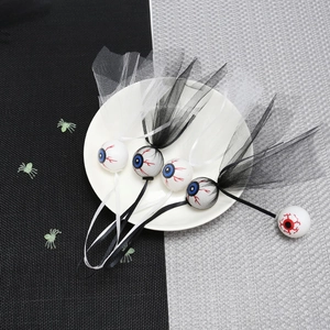 Detailed view of Halloween eyeball hanging ornaments with black and white mesh decorations