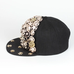 Detail of black hip hop baseball cap with gold metal rivets and embossed medals