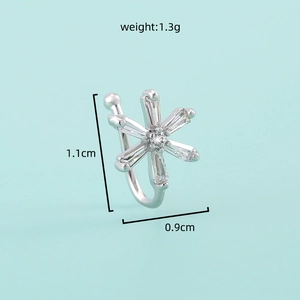 Detail shot of silver snowflake nose cuff with dimensions 1.1cm by 0.9cm and weight 1.3g