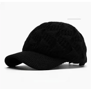 Close-up of black knitted baseball cap featuring vintage cable knit texture and curved brim