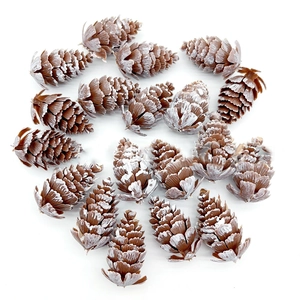 Detailed close-up of artificial pine cones with white snow frost for Christmas decor