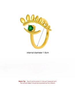 Macro shot of gold evil eye ring with green stone detailing product dimensions and weight