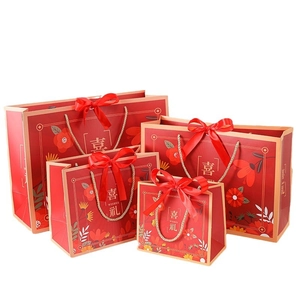 Red Chinese wedding gift bags with ribbon bows in four sizes for candy and favors