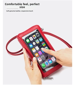 Macro shot of red leather phone bag featuring a sensitive touch screen window for easy access